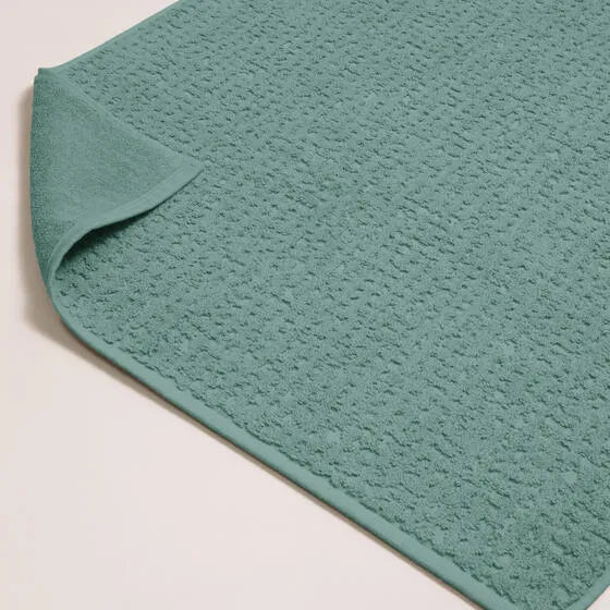 Luxe mineraalblauw Florence badmat van 100% GOTS-katoen, 600 g/m², hoge kwaliteit, zacht en absorberend.
