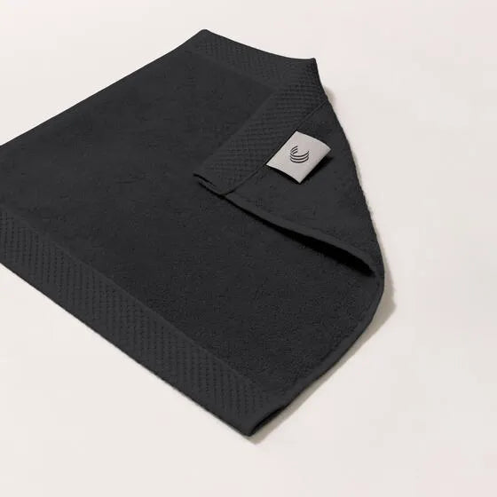 Luxe antraciet Florence gezichtsdoeken (4 stuks) van 100% GOTS-katoen, 600 g/m², hoge kwaliteit, zacht en absorberend.
