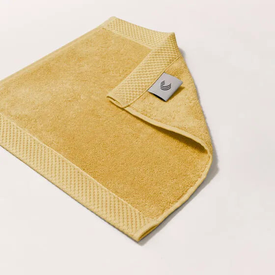 Luxe oker Florence gezichtsdoeken (4 stuks) van 100% GOTS-katoen, 600 g/m², hoge kwaliteit, zacht en absorberend.